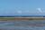 LA REUNION, Lagon du petit village de grand-bois - lagon en maree basse et pecheur creole sur barierre de corail : margouillat photo.